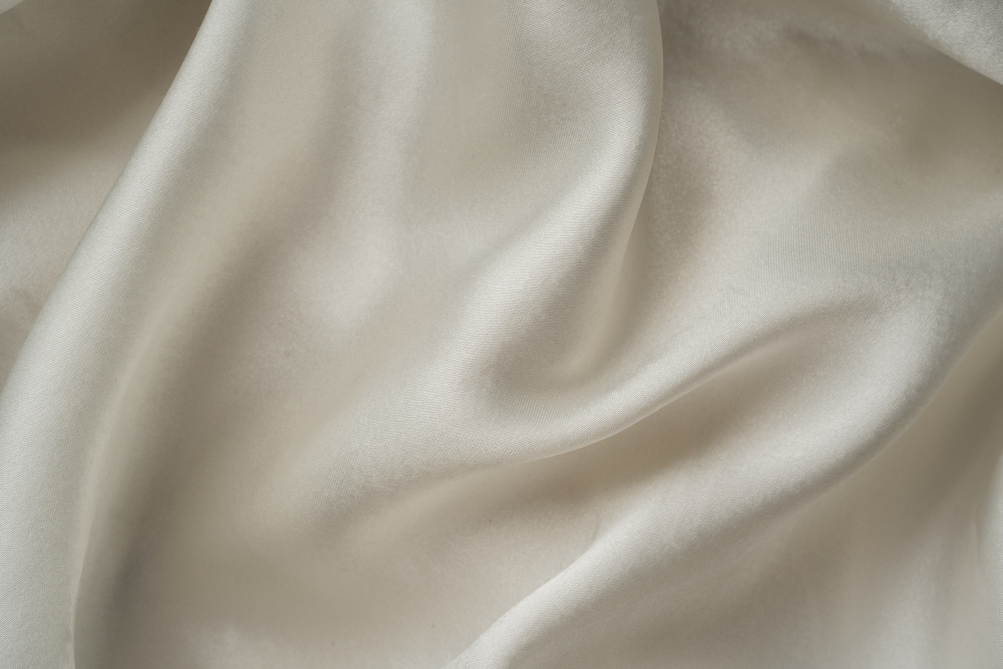 Blurred Background of a White Soft Satin Fabric 